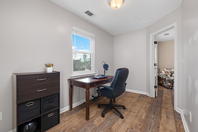 home office with wood-type flooring