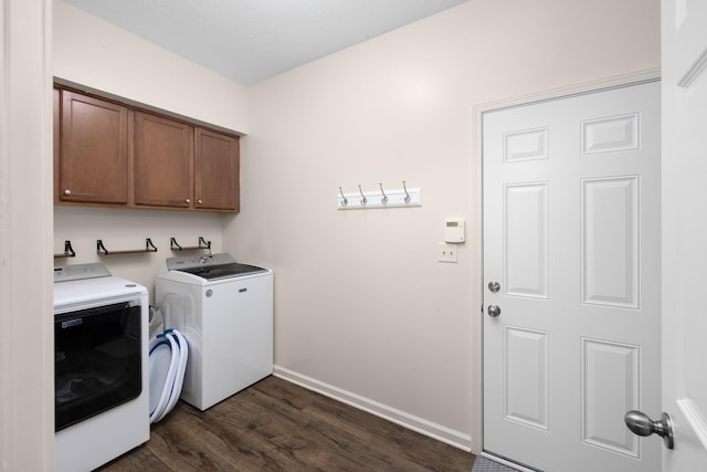 washroom featuring cabinets, dark hardwood / wood-style flooring, and washer and dryer