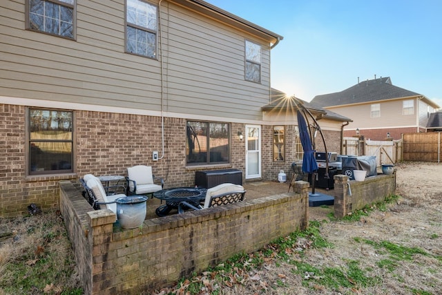 rear view of property with an outdoor fire pit and a patio area