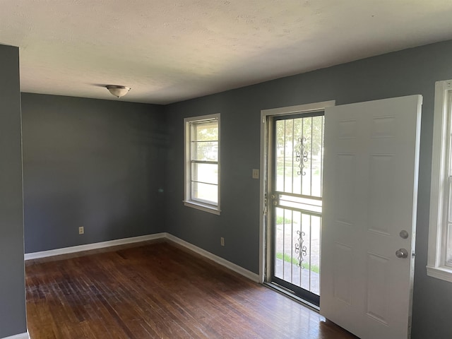 foyer entrance with dark hardwood / wood-style flooring