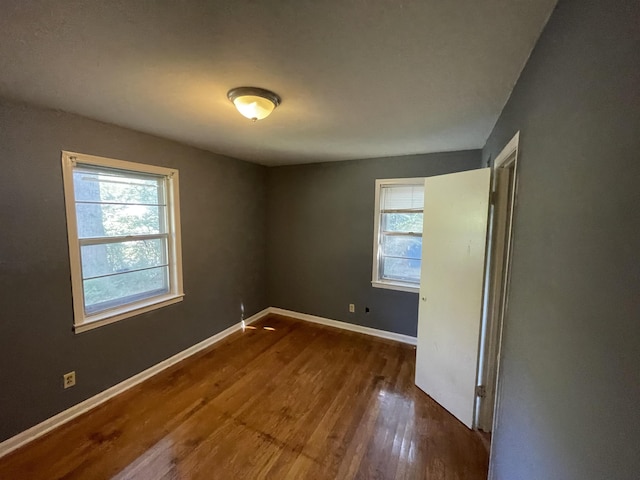 spare room with dark wood-type flooring