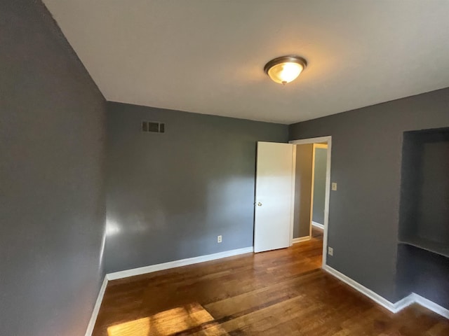 unfurnished bedroom with hardwood / wood-style flooring