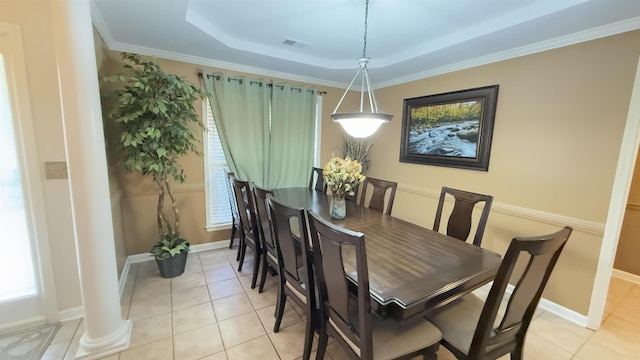 dining space featuring ornate columns, crown molding, light tile patterned floors, and a tray ceiling