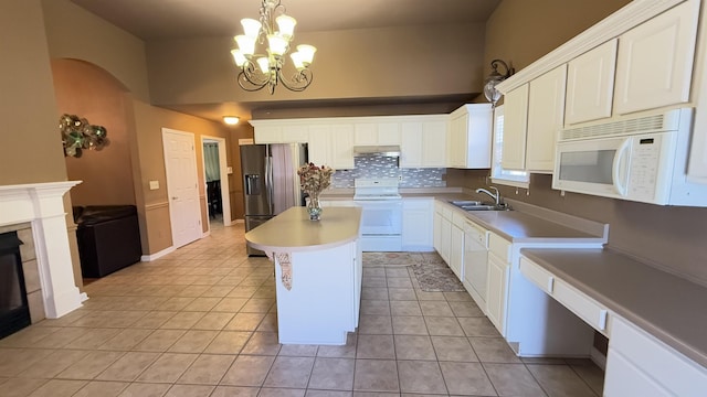 kitchen with white cabinets, white appliances, pendant lighting, a chandelier, and a kitchen island