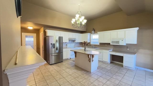 kitchen featuring white appliances, backsplash, white cabinets, light tile patterned floors, and a kitchen island