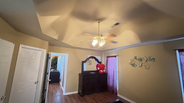 interior space with ceiling fan and dark wood-type flooring