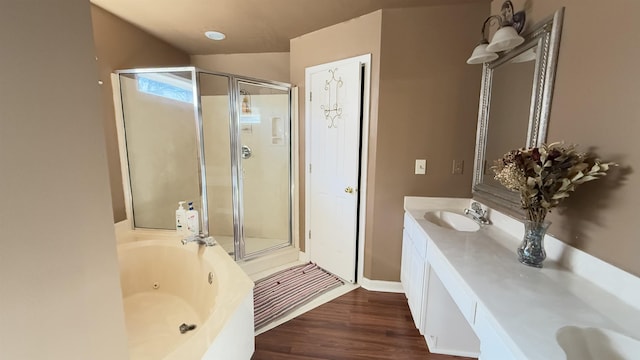 bathroom featuring vanity, hardwood / wood-style flooring, and separate shower and tub