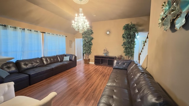 living room featuring wood-type flooring and an inviting chandelier