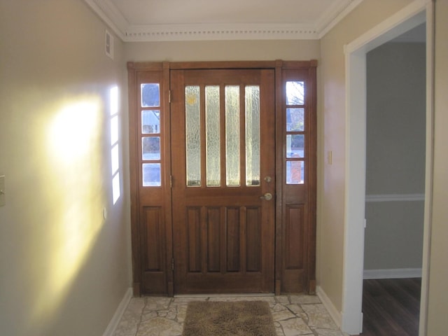 foyer featuring plenty of natural light and ornamental molding