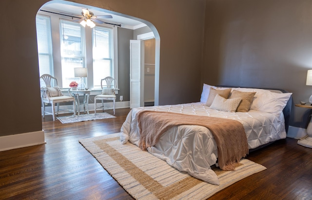 bedroom featuring ceiling fan, dark hardwood / wood-style flooring, and ornamental molding