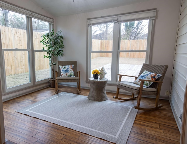 living area with lofted ceiling and dark wood-type flooring