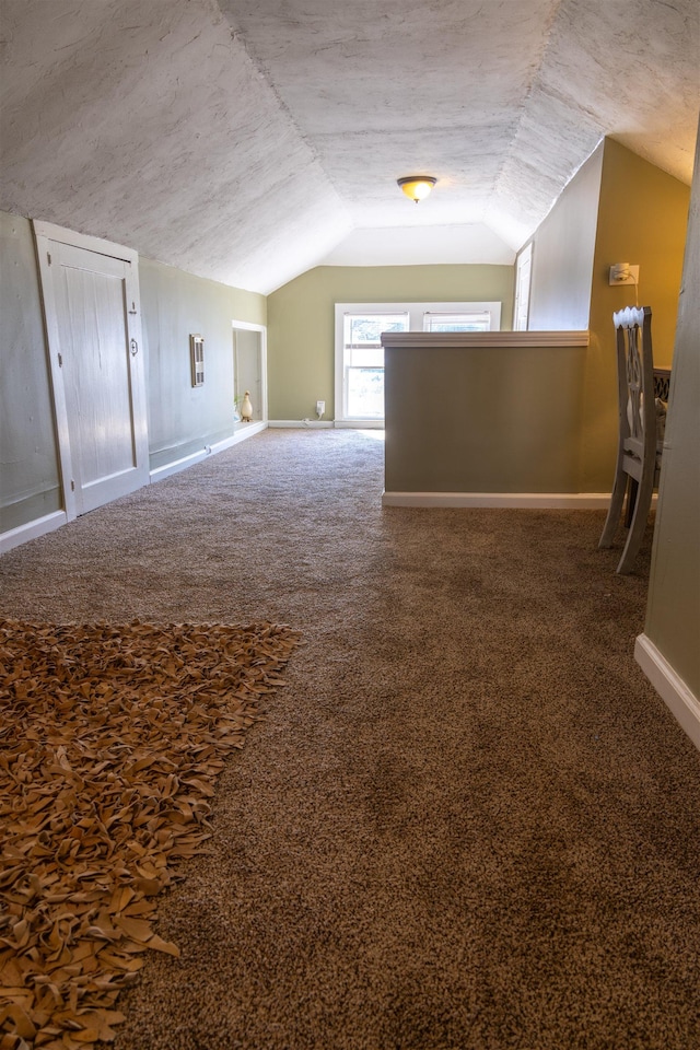 bonus room featuring carpet flooring, a textured ceiling, and vaulted ceiling