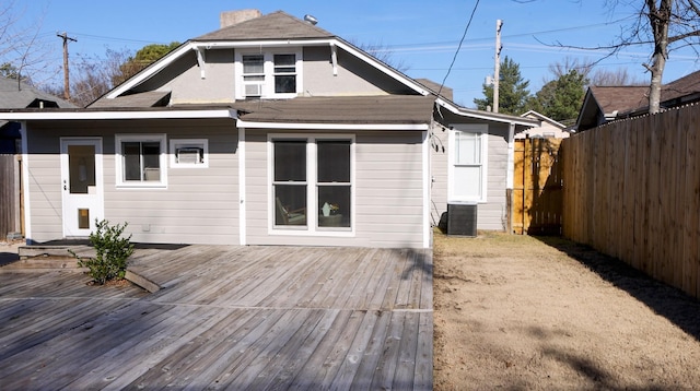 back of property with central AC unit and a wooden deck