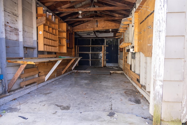 misc room with vaulted ceiling and concrete floors