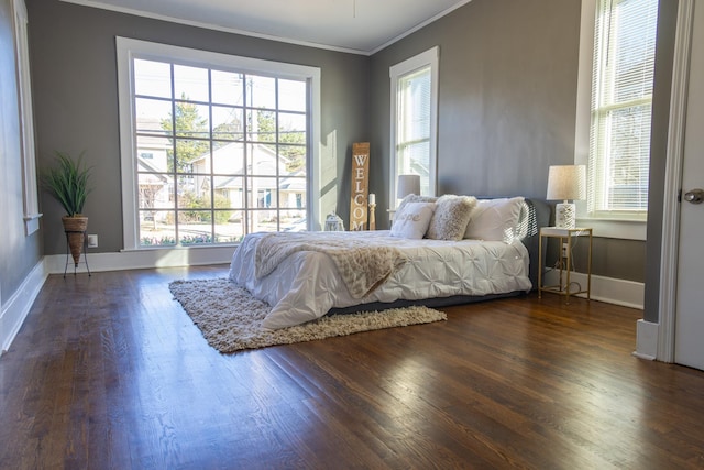 bedroom with dark wood-type flooring and ornamental molding