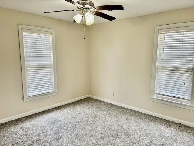 empty room with ceiling fan and carpet