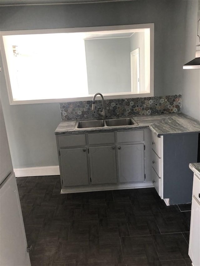 kitchen with gray cabinetry and sink