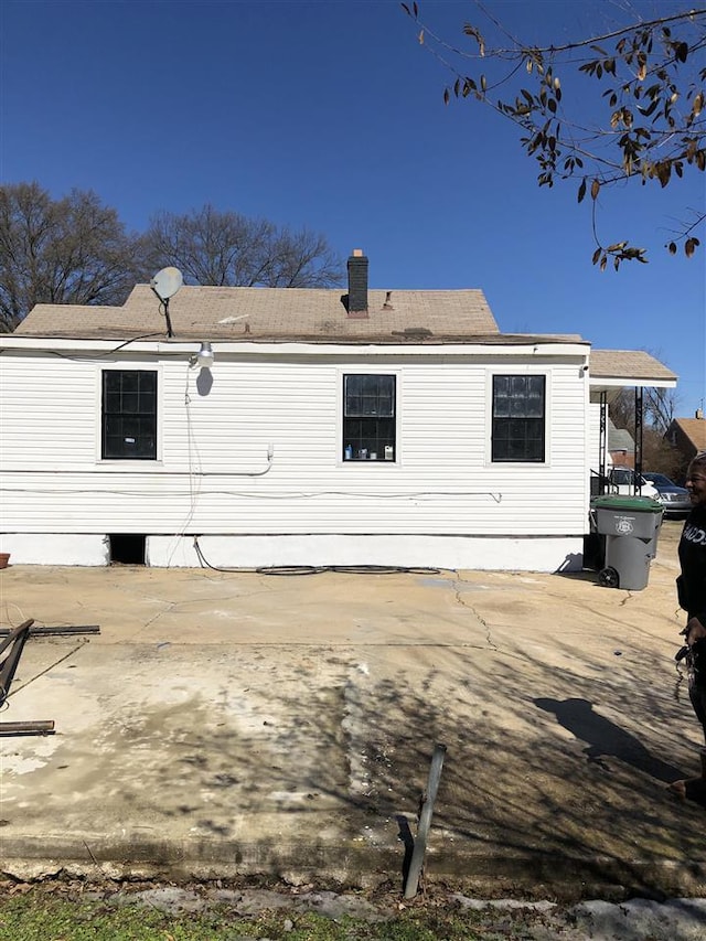 back of property with a patio