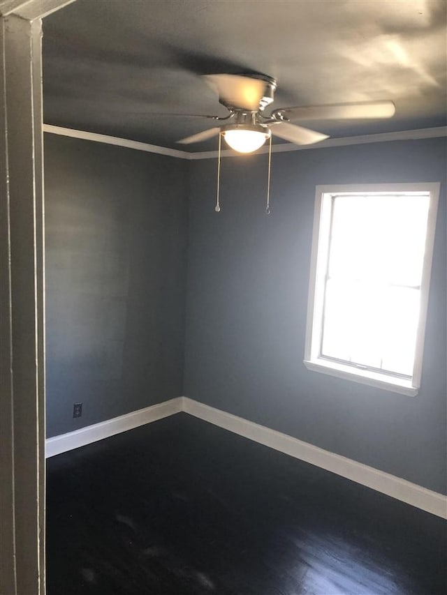 empty room with hardwood / wood-style flooring, ceiling fan, and crown molding