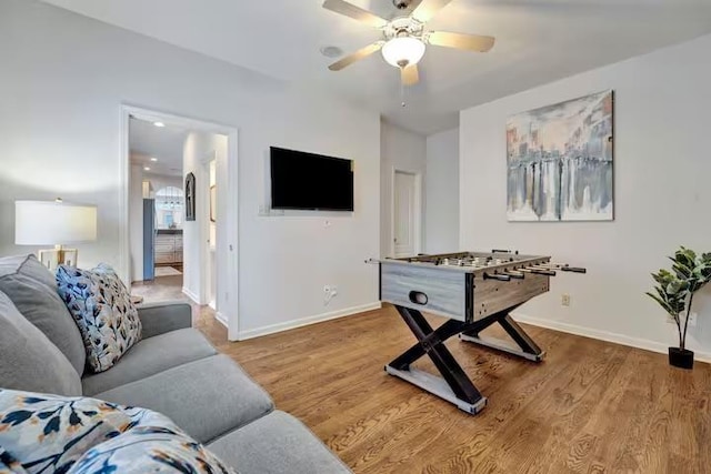 playroom with wood-type flooring and ceiling fan