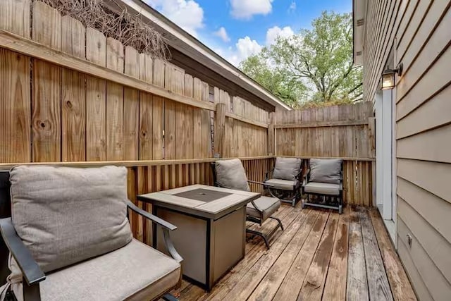 wooden terrace featuring a fire pit