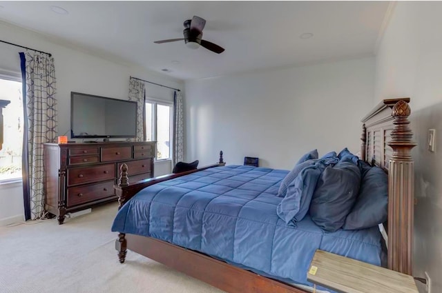 carpeted bedroom with multiple windows and ceiling fan