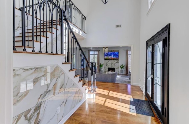 foyer featuring hardwood / wood-style floors, french doors, and a high ceiling