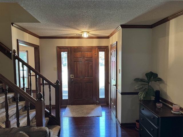 foyer entrance featuring a textured ceiling, dark hardwood / wood-style flooring, and crown molding