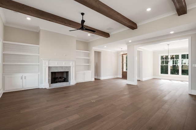 unfurnished living room featuring crown molding, ceiling fan with notable chandelier, dark hardwood / wood-style floors, and a premium fireplace