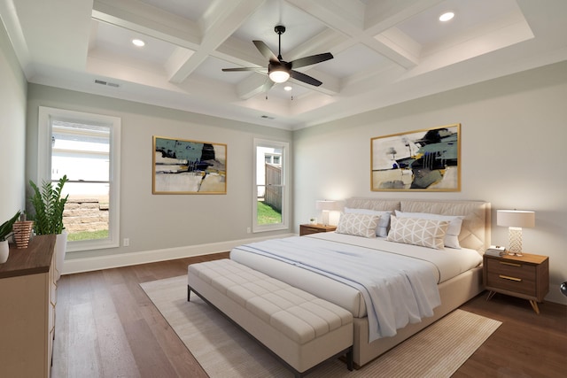 bedroom featuring beamed ceiling, dark hardwood / wood-style flooring, coffered ceiling, and ceiling fan