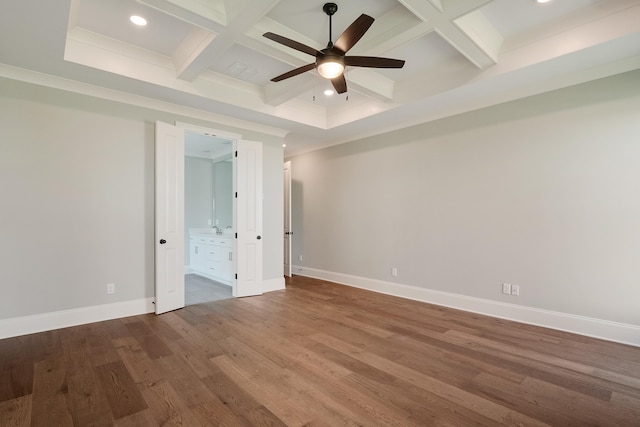 empty room with coffered ceiling, hardwood / wood-style floors, and beam ceiling