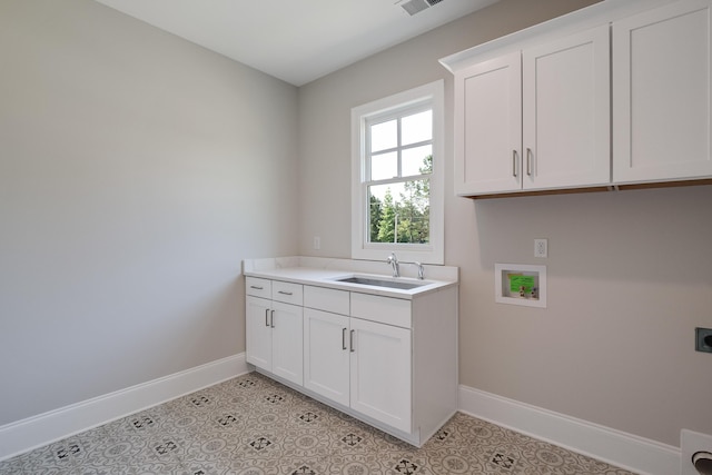 laundry room with sink, cabinets, light tile patterned floors, hookup for a washing machine, and hookup for an electric dryer