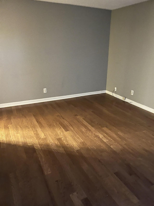 spare room with dark hardwood / wood-style floors