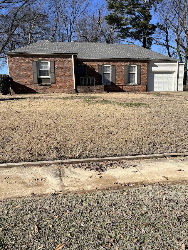 single story home featuring a front yard and a garage