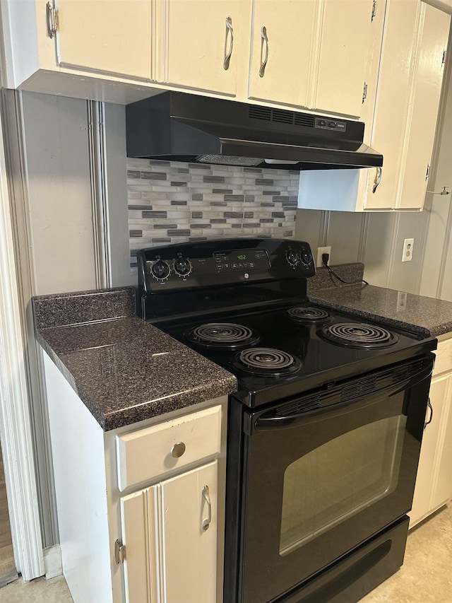 kitchen featuring dark stone counters, electric range, decorative backsplash, and white cabinetry