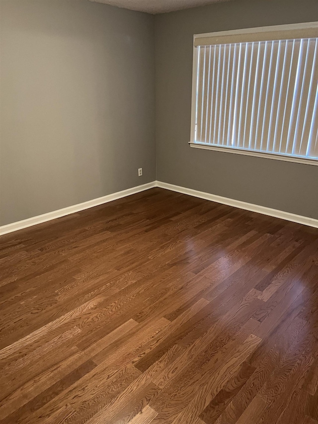 unfurnished room featuring hardwood / wood-style floors