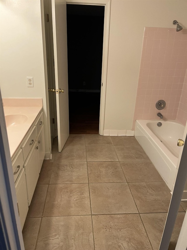 bathroom with tile patterned flooring, bathtub / shower combination, and vanity