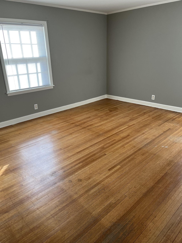 unfurnished room featuring crown molding and wood-type flooring