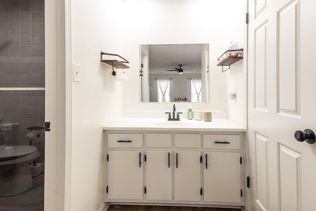 bathroom featuring ceiling fan, toilet, and vanity