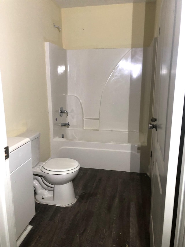 bathroom featuring toilet,  shower combination, and hardwood / wood-style flooring