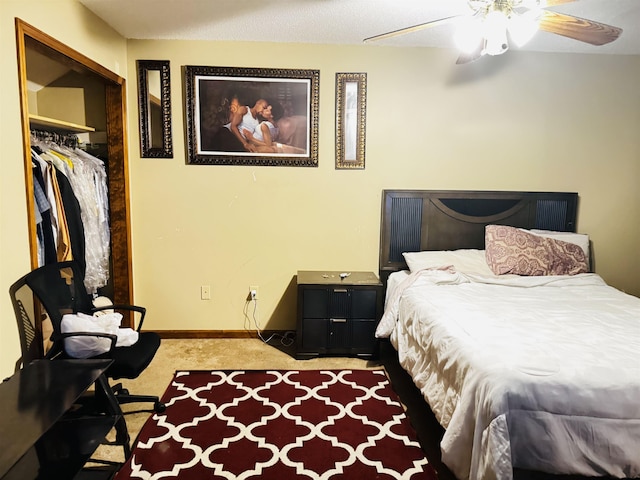 carpeted bedroom with ceiling fan and a closet