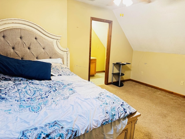 bedroom with connected bathroom, light carpet, ceiling fan, and vaulted ceiling