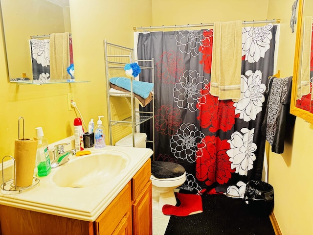 bathroom featuring tile patterned flooring, vanity, curtained shower, and toilet