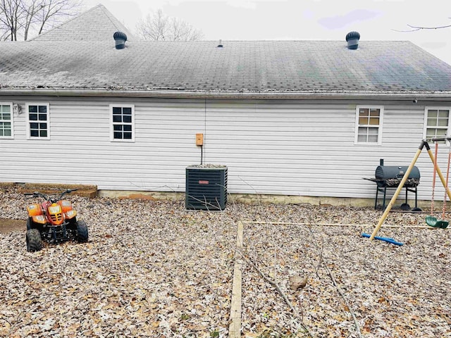 view of side of property with central air condition unit