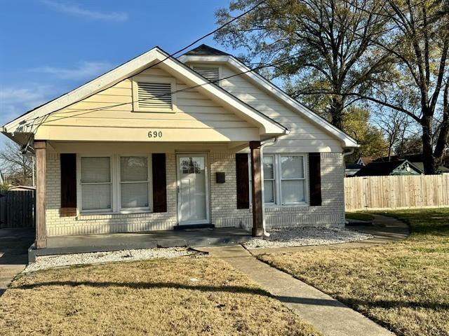 bungalow-style home featuring a front lawn and a porch