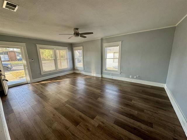 empty room featuring a textured ceiling, ceiling fan, dark hardwood / wood-style flooring, and crown molding