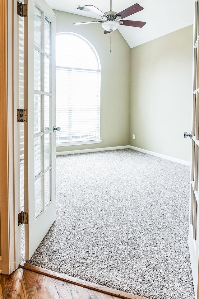 spare room featuring ceiling fan, a wealth of natural light, and french doors