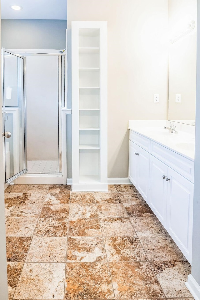 bathroom featuring vanity and a shower with shower door