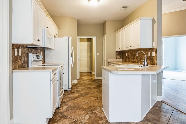 kitchen with white cabinets, range with electric cooktop, kitchen peninsula, and backsplash