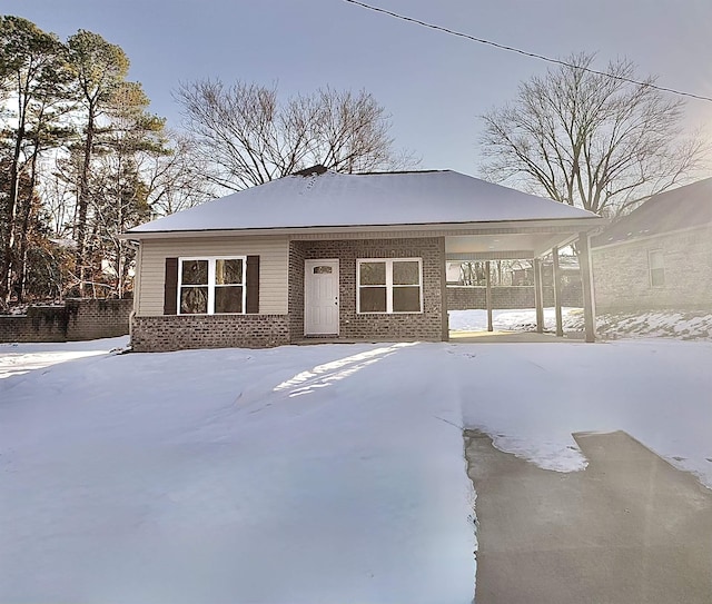 view of front of property with a carport and brick siding